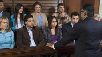 A prosecuting attorney addresses jurors in the jury box during a trial. | Photographerlondon | Dreamstime.com
