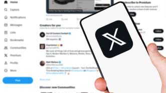 A hand holds a cell phone with the logo for X (formerly Twitter) on the screen, while in the background, a computer displays the X homepage. | Boarding1now | Dreamstime.com